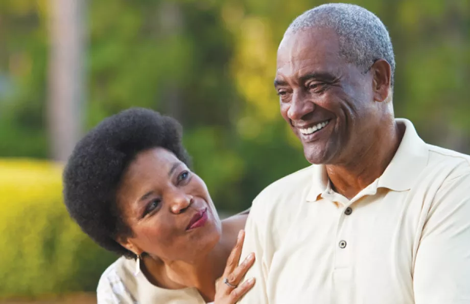 A man and woman enjoy their walk together outside.