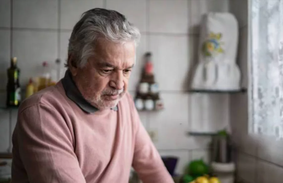 Distressed Hispanic man in a kitchen