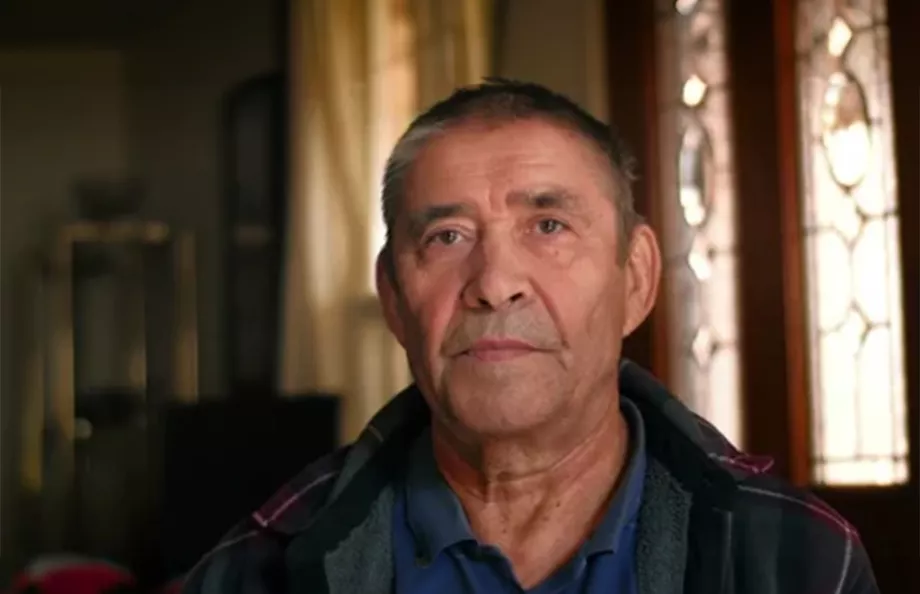 Hispanic man sitting in a dimly lit room