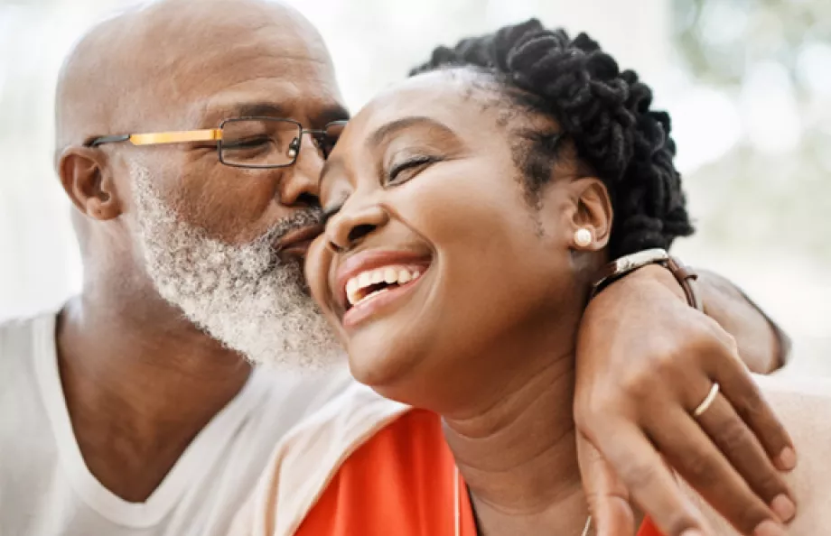 Old man giving a woman a kiss on the cheek