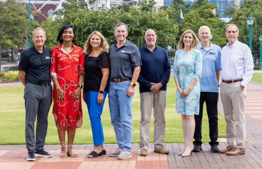 A group of professionals standing outside in a park