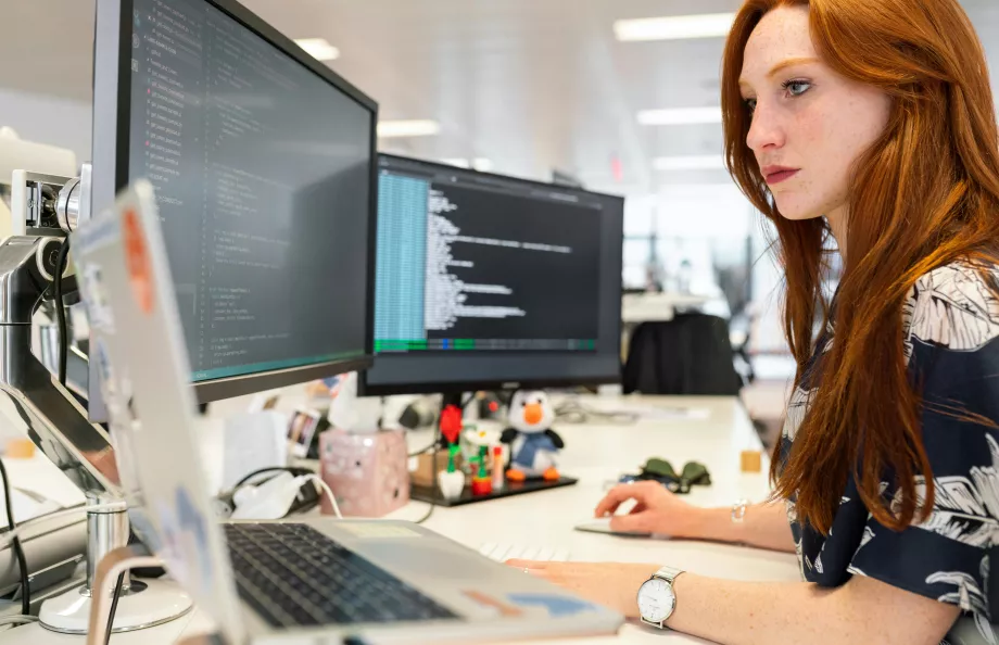 Woman looking at computer monitors