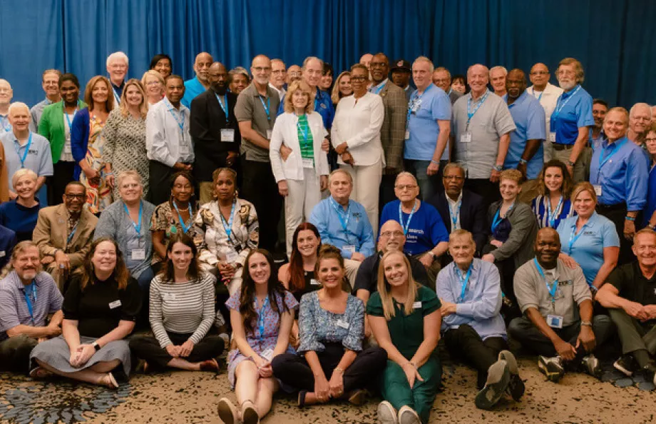 A group of people from the SGL and MENtor training session pose together for a photo