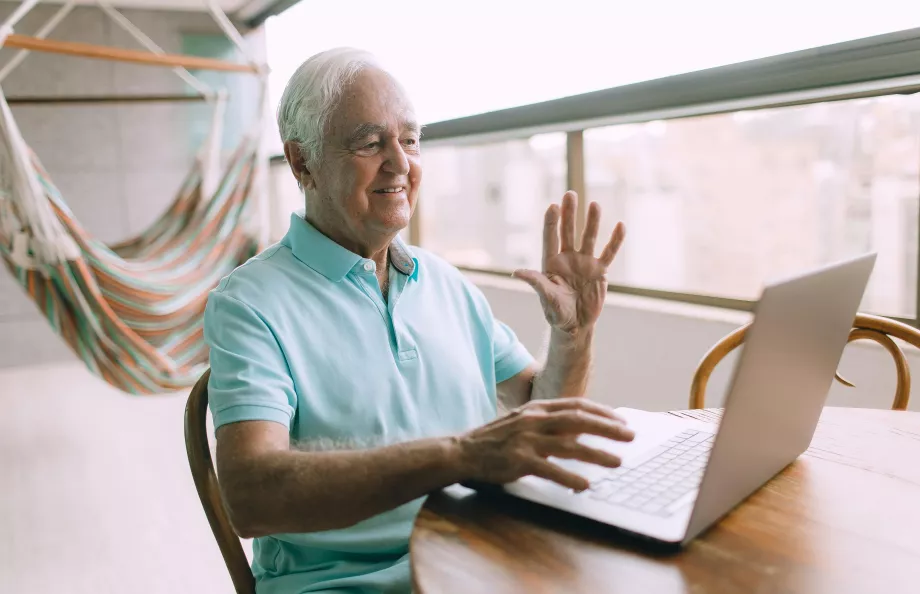 A man waves to the online support group members during a virtual meeting.