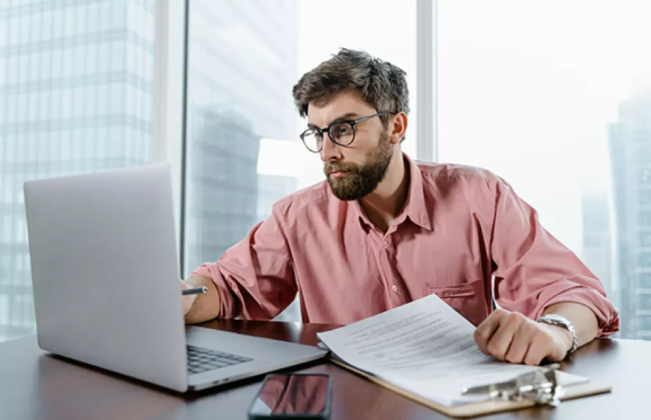 man looking at computer in office