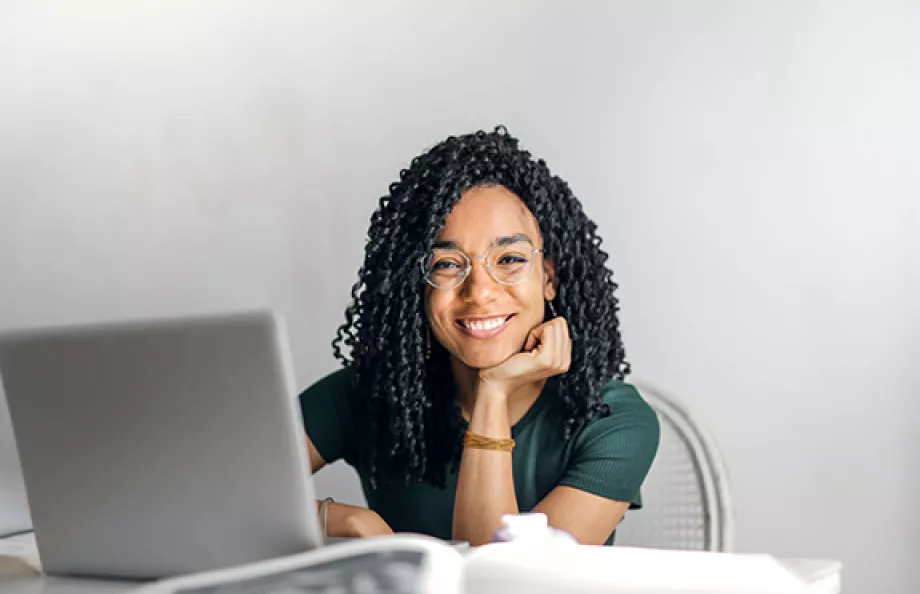 woman sitting at desk with glasses