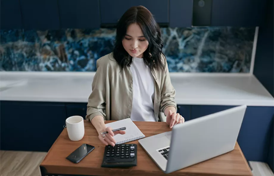 woman sitting at desk with computer and glasses