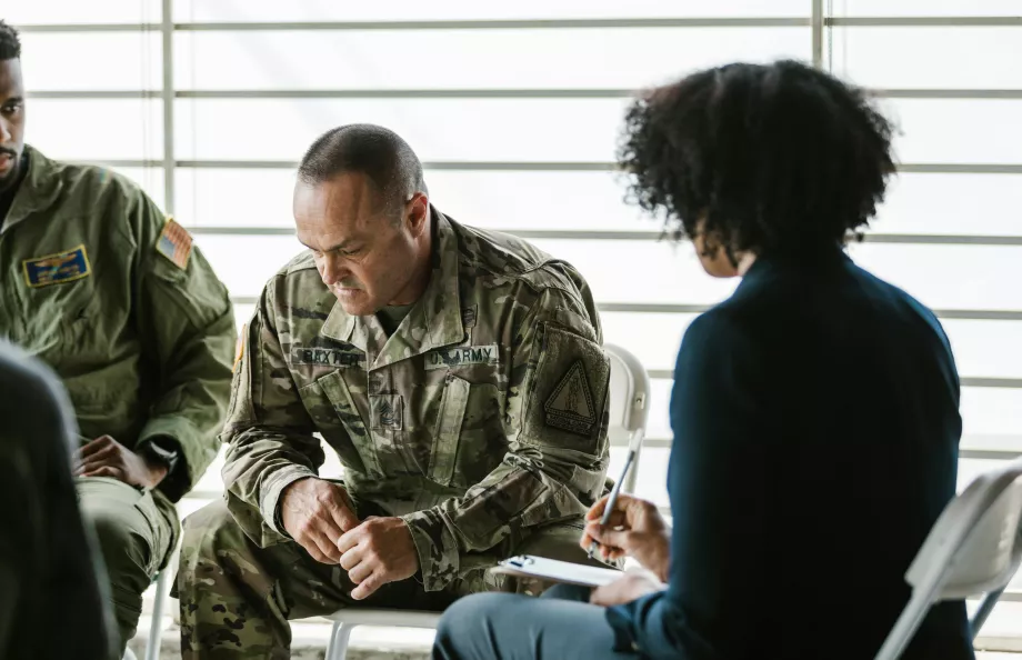 Woman talking to a veteran sitting down