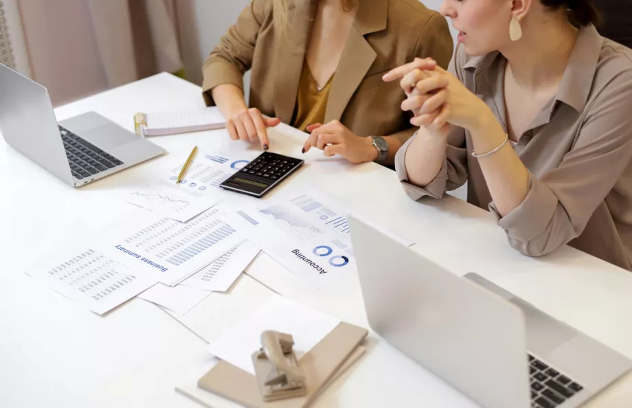 Two people sitting at a table doing finances