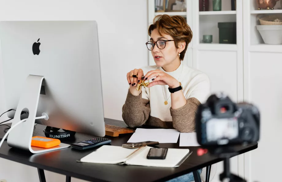 Woman looking at computer screen at desk
