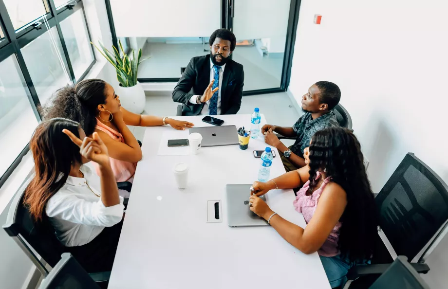 Man sitting at conference table with other colleagues