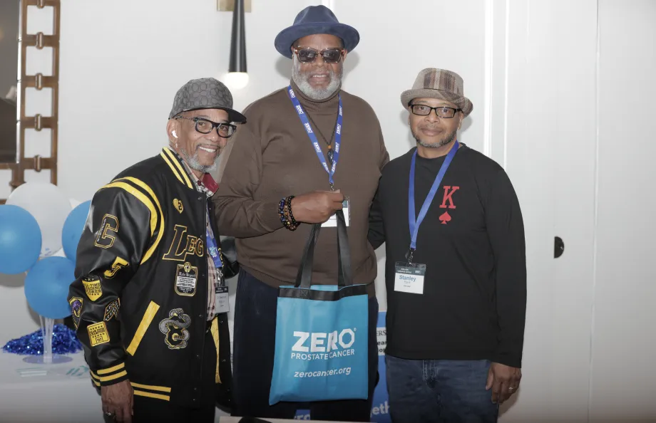 Three people smiling and standing shoulder to shoulder